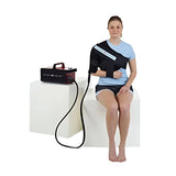 Woman seated wearing a Game Ready shoulder wrap connected to the control unit